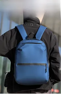Blue waterproof backpack with double front zippers shown on model for size and fit