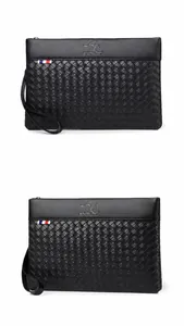 Detail view of black woven texture clutch with kangaroo logo and wrist strap for men