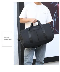 Close-up of black nylon gym bag with reinforced handles and side zipper pocket
