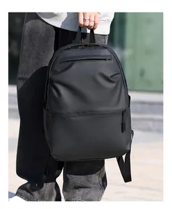 Close-up of matte waterproof fabric and front zipper pocket on black commuter backpack
