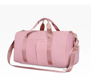 Detailed side view of pink fitness bag with front pockets and golden hardware accents