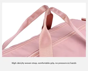 Detail view of the pink travel bag featuring reinforced handles and smooth metal zippers