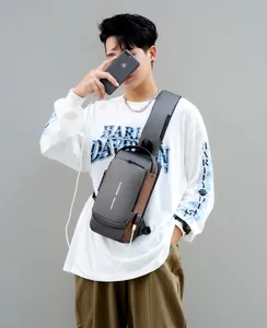 Detail of chest bag showing the integrated USB charging port and functional zip pocket