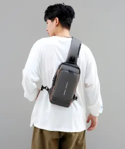 Detail view of anti-theft combination lock and reflective strip on dark grey men's chest bag