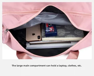Spacious main compartment of pink fitness bag holding a laptop, umbrella and notebook