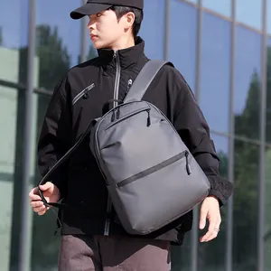 Minimalist dark gray business travel backpack with a matte finish on modern background