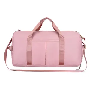 Detailed view of a pink waterproof fitness bag with double front pockets and soft texture