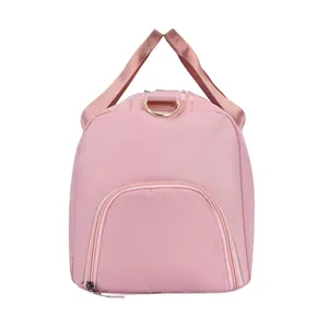 Detailed side view of pink travel bag showing waterproof fabric and zipper pocket