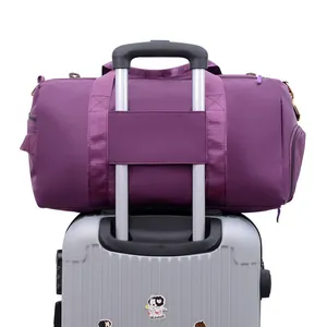 Purple large capacity travel bag with luggage strap fixed on silver grey suitcase