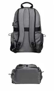 Détail des bretelles ergonomiques et de la sangle de bagage sur un sac à dos gris