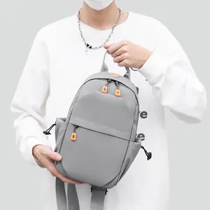 Waterproof grey men's crossbody chest bag with orange zipper puller and drawstring pockets