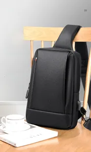 Close-up of black Oxford fabric chest bag with integrated USB port and shoulder strap detail