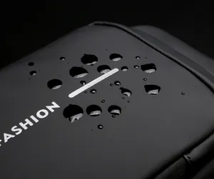 Macro detail of waterproof nylon crossbody bag showing water droplets on fabric