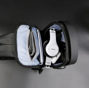 Internal view of nylon sling bag with multiple compartments and light blue lining