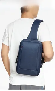 Rear view of a model wearing the navy blue oxford fabric chest bag for men's casual style