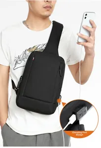 Detail of the external USB charging port on a black Oxford cloth crossbody sling bag for men