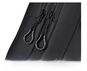 Detailed macro view of the durable dual-zipper system on this black waterproof sling bag