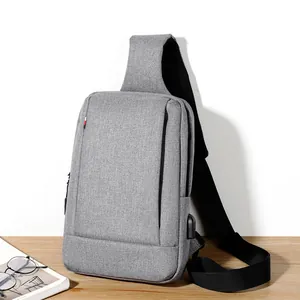 Men's light grey oxford chest bag with USB charging port for urban commuting
