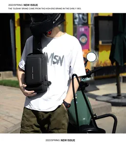 Detail of black waterproof sling bag for men featuring external USB charging port