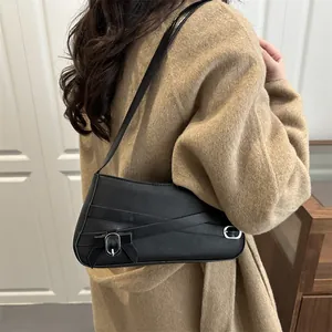 Elegant black faux leather shoulder bag with decorative metallic buckle strap for women