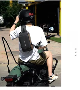 Waterproof men's sling bag with USB charging port shown in an outdoor cycling scene