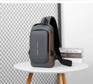 Detail view of water-resistant shoulder bag with USB port and reflective safety strip