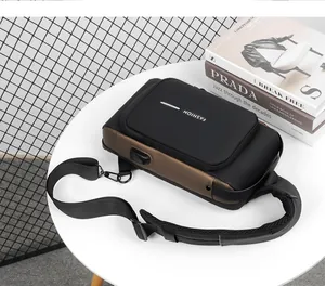 Detail view of water-resistant chest bag with USB charging port and mixed leather design