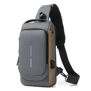 Waterproof men's sling bag in grey and tan with built-in USB charging port and breathable strap