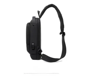 Side view of black waterproof crossbody bag featuring an external USB charging port