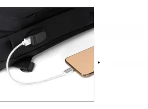 Detail of the external USB charging port on a black waterproof crossbody sling bag