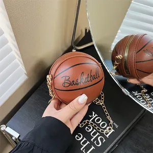Detail of creative basketball-shaped crossbody bag with grain texture and gold chain