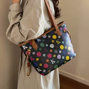 Large tote bag with colorful letter print and brown shoulder straps in a side view