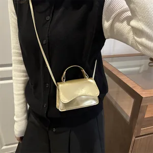 Mini borsa quadrata in vernice dorata lucida con manico e finitura metallizzata