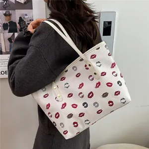 Large capacity tote bag with red lip print and long straps shown on a female model