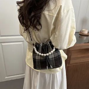 Plaid drawstring bucket bag featuring a pearl handle and chain strap for women