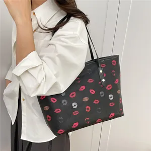 Black leather tote bag with colorful lip prints and slim rivet straps for women
