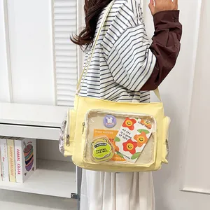 Yellow canvas crossbody bag with clear heart window for anime pins and cards