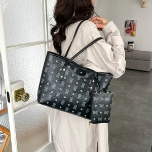 Black pebbled leather tote set with blue bear pattern and matching inner pouch