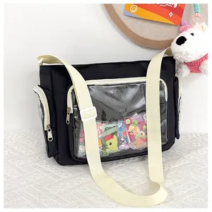Detail of black ita bag with clear PVC windows and adjustable shoulder strap for display