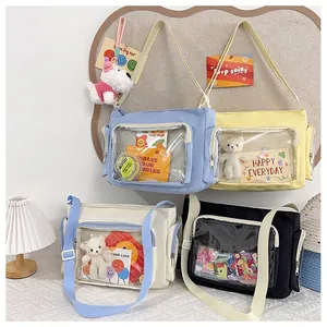 Detail of canvas messenger bags with transparent PVC window for decorative items