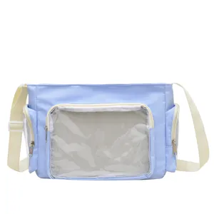 Light blue crossbody ita bag with clear PVC front window and adjustable shoulder strap