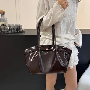 Sac à épaule en cuir verni marron foncé avec détail nœud et fermoir doré chic