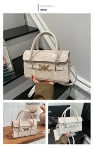 Detail showing white crocodile embossed leather texture and golden metal D-ring buckle