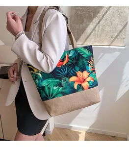 Detail of canvas tote bag featuring tropical floral prints and khaki linen patchwork
