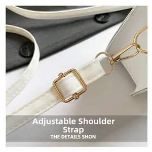 Detail of adjustable white leather strap with premium gold metal buckles and fine stitching