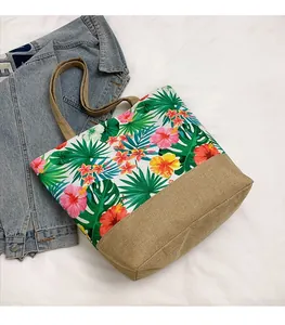 Detail of tropical floral canvas tote with jute base and palm leaf pattern fabric