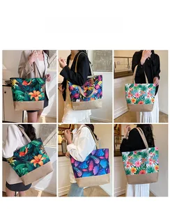 Detail view of large canvas tote bag with tropical floral prints and woven texture base