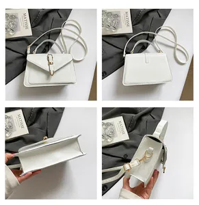 Detail view showing minimalist white crossbody bag with gold buckle and adjustable strap