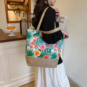 Floral canvas tote bag with tropical hibiscus print and jute trim in cafe setting