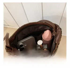Detail view of the spacious inner compartment with zip closure and leopard print lining